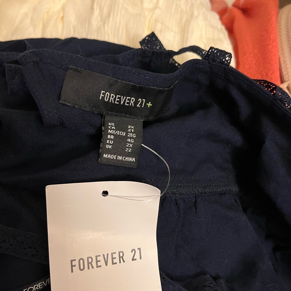 Forever 21 size 2x navy blue shirt with embroidered Flowers on it.